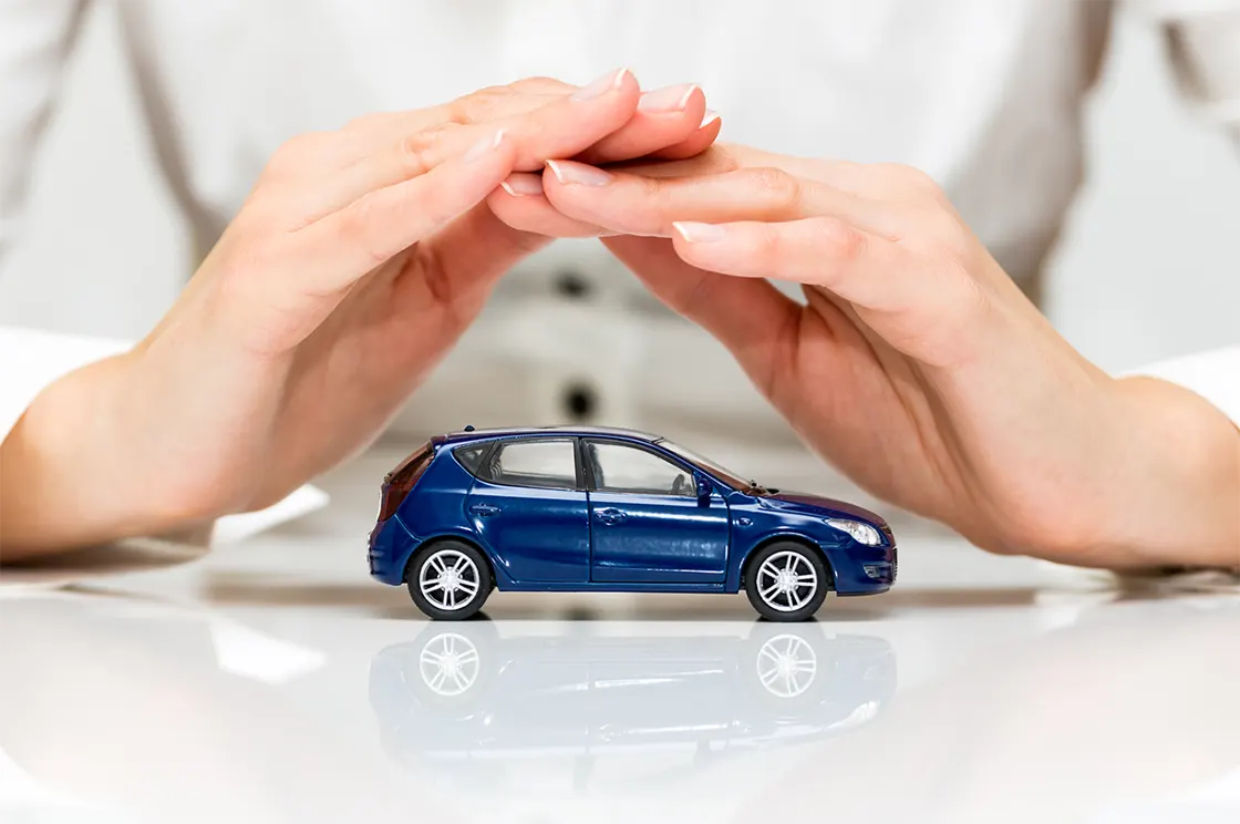 Kasko Değer Listesi 2024. Maket arabayı koruma altına alan eller.